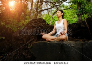 stock-photo-woman-training-yoga-and-meditation-on-the-rock-at-the-mountain-138638348